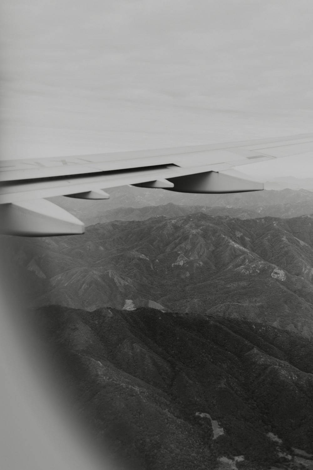 a black and white photo of the wing of an airplane