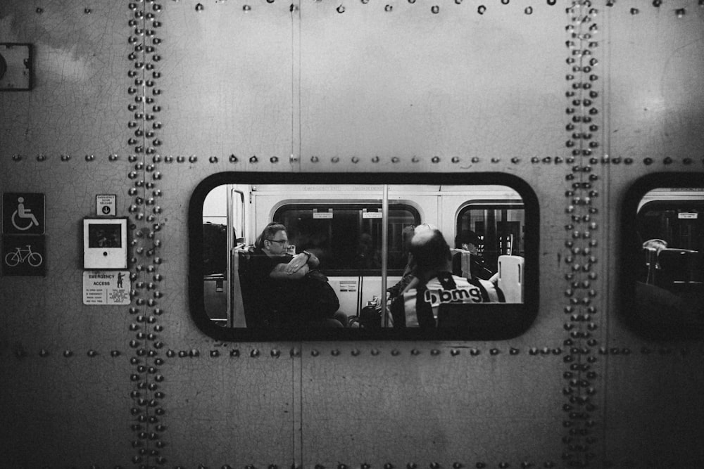 a couple of people that are sitting in a train