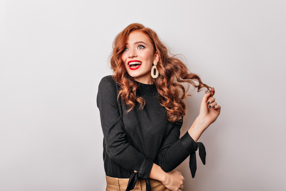 a woman with red lips and a black shirt