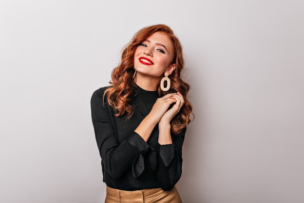 a woman wearing a black shirt and gold skirt