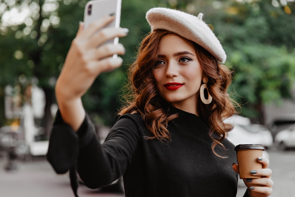 a woman taking a selfie with her cell phone