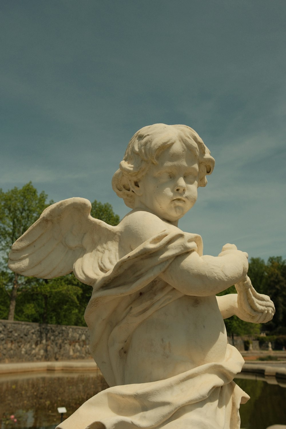 a statue of an angel holding a book