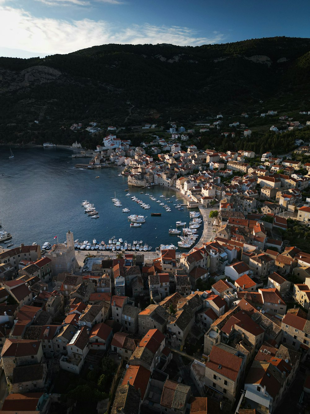 an aerial view of a city with boats in the water