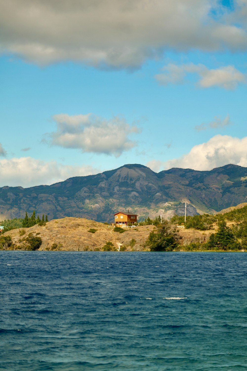 a large body of water with mountains in the background