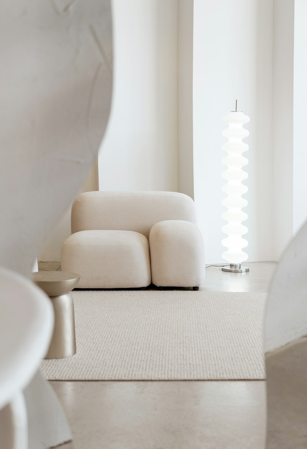 a white couch sitting in a room next to a window