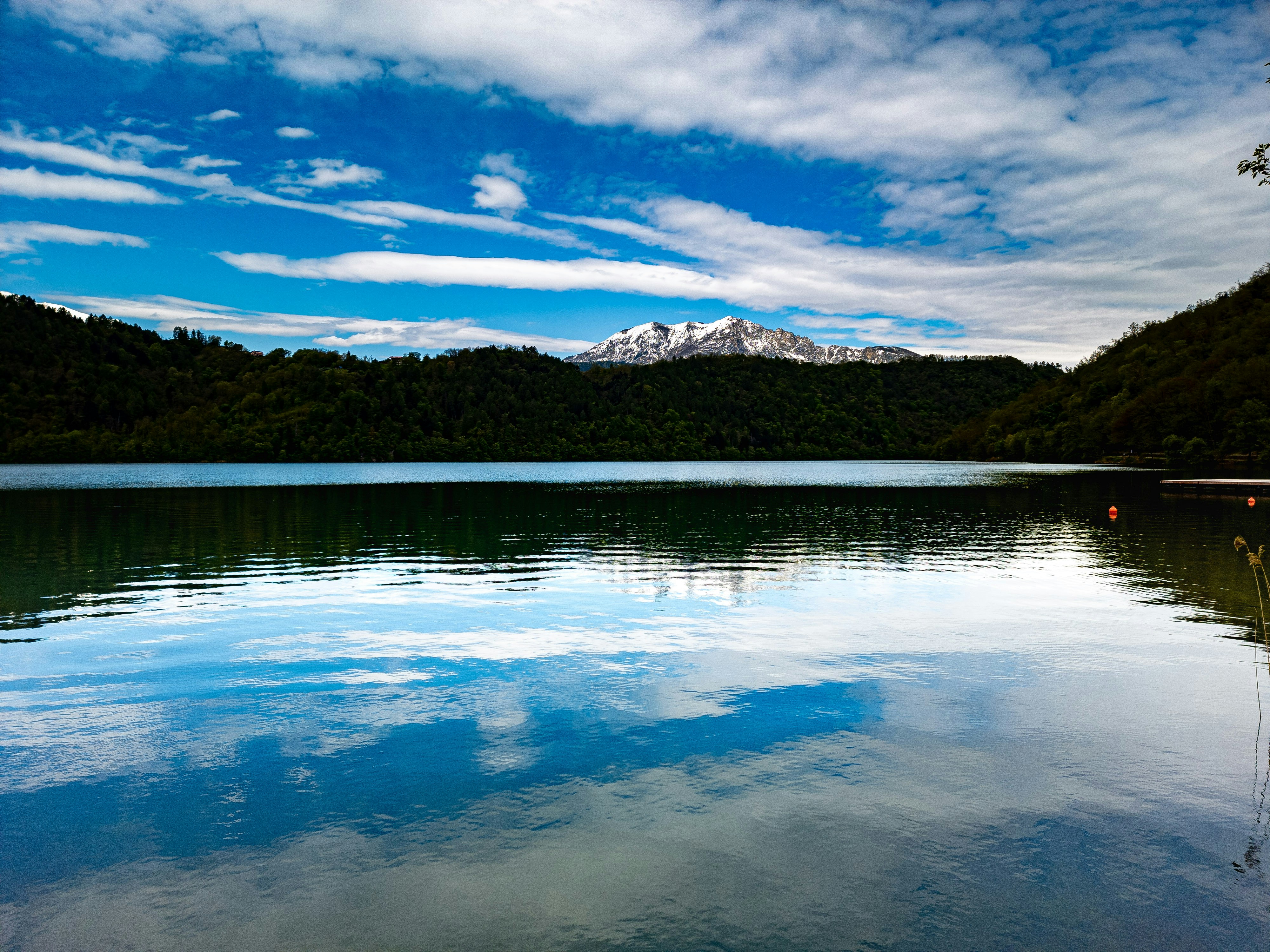 a body of water with a mountain in the background