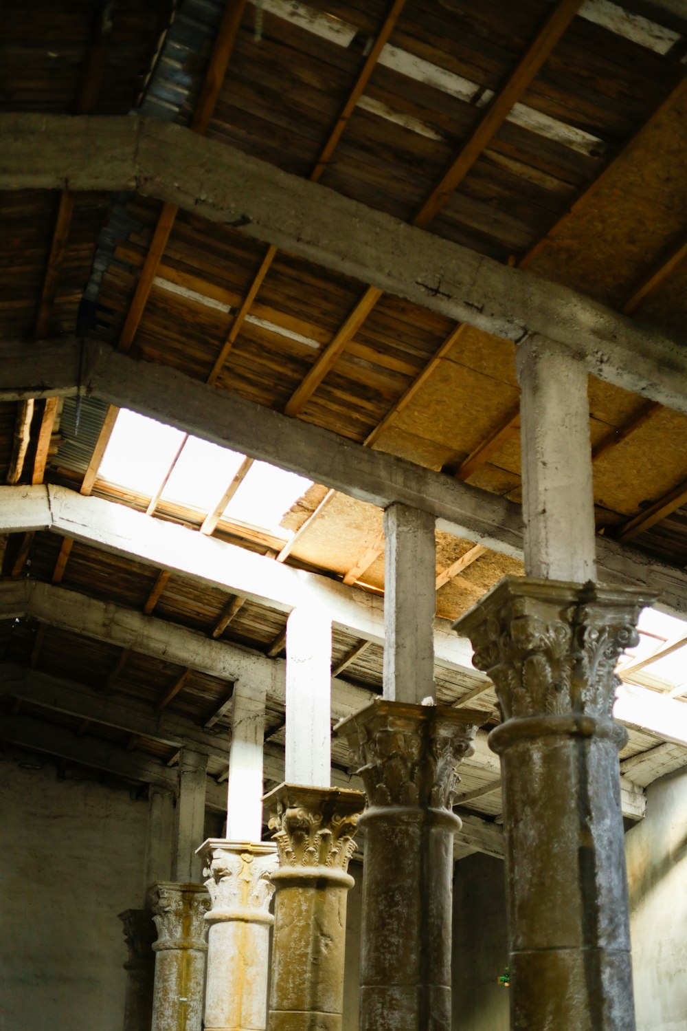 a group of pillars in a building with a skylight