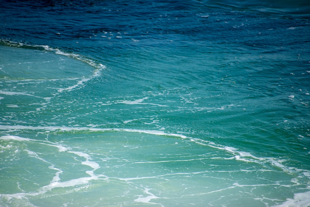 a person riding a surfboard on a wave in the ocean