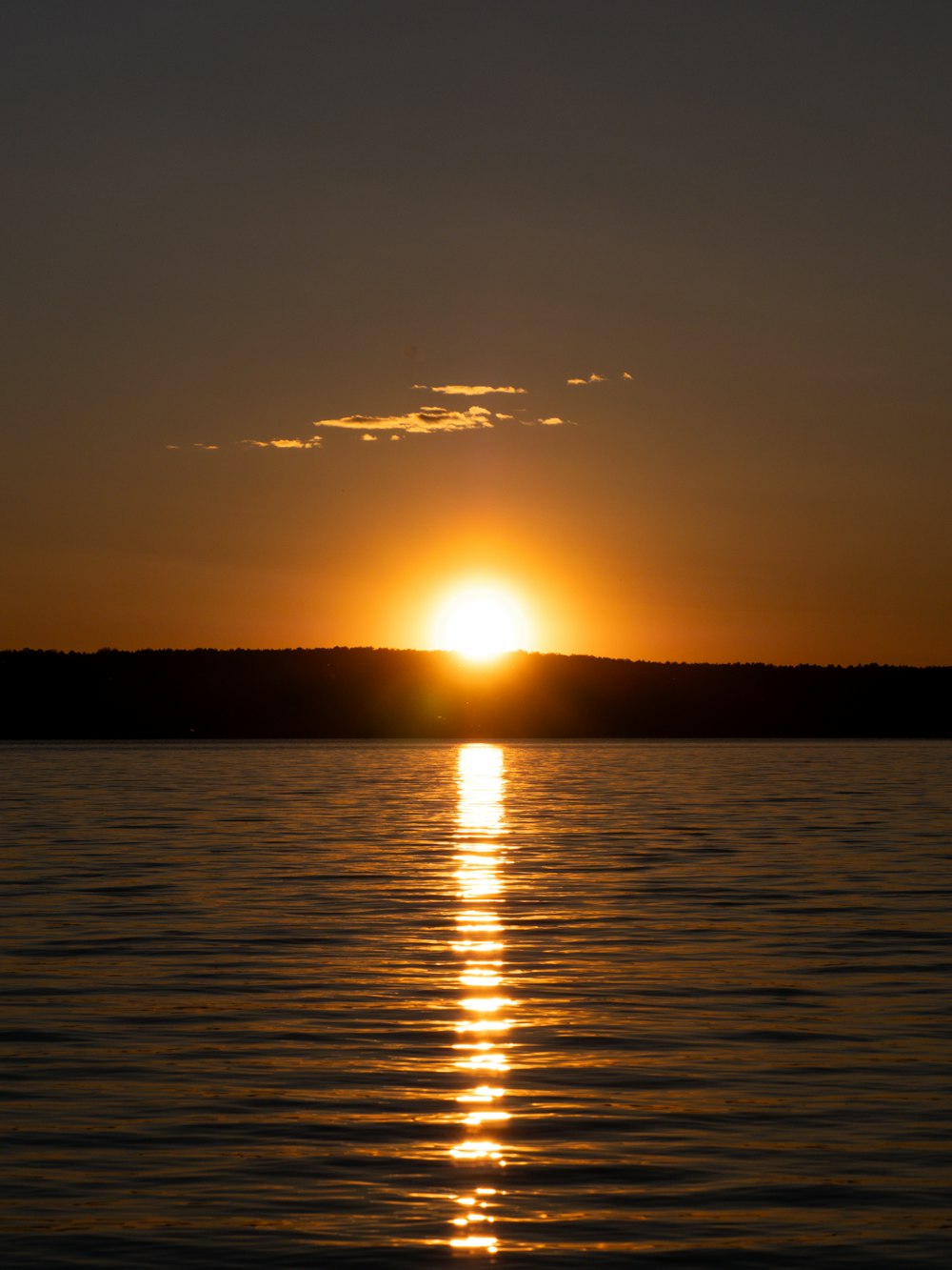 the sun is setting over a body of water