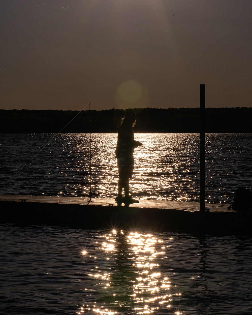 a person standing on the edge of a body of water