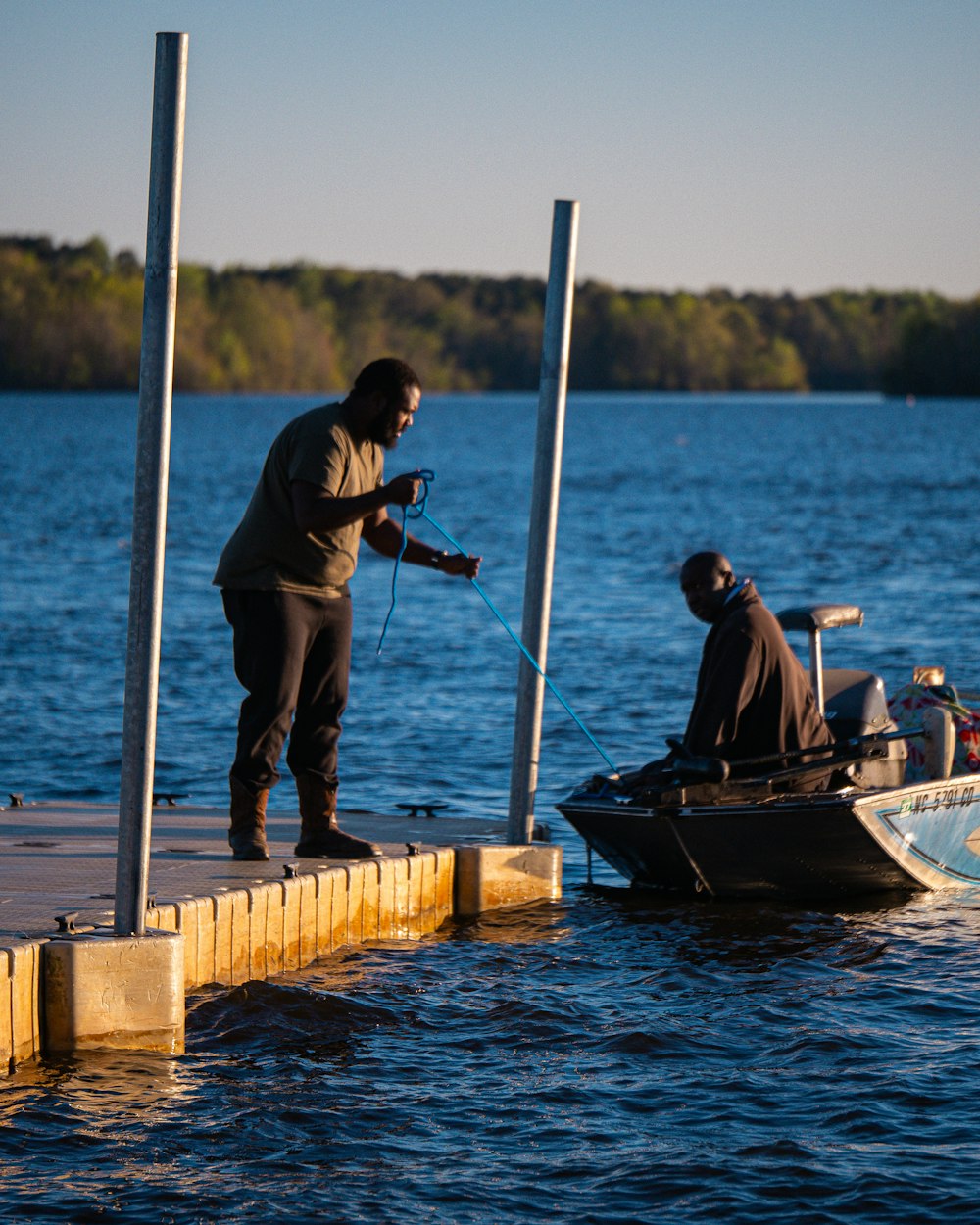 a man standing on a dock next to a boat