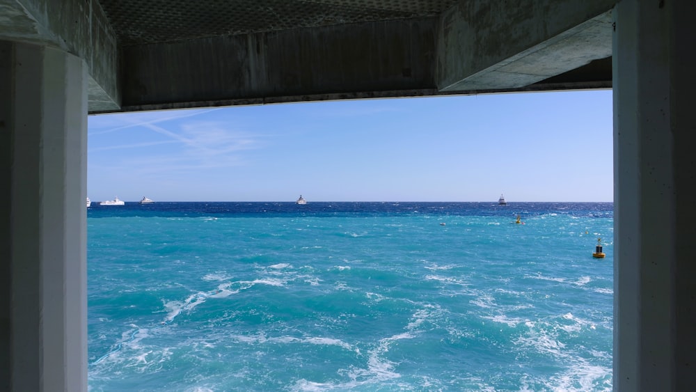 a view of the ocean from inside a building