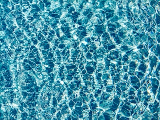a pool with blue water is shown from above