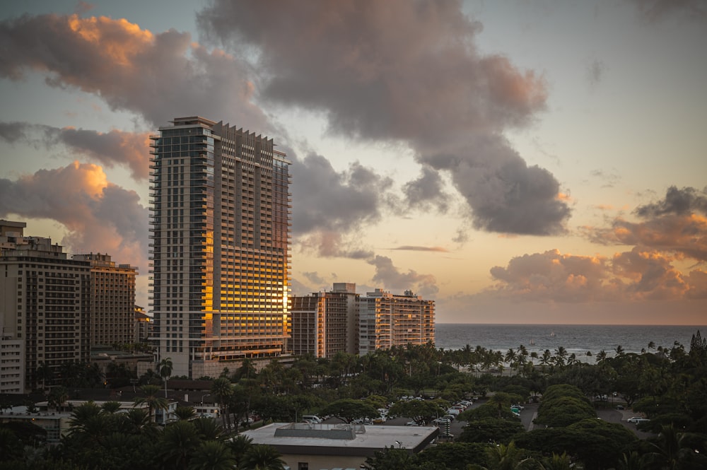 a view of a city at sunset with clouds in the sky