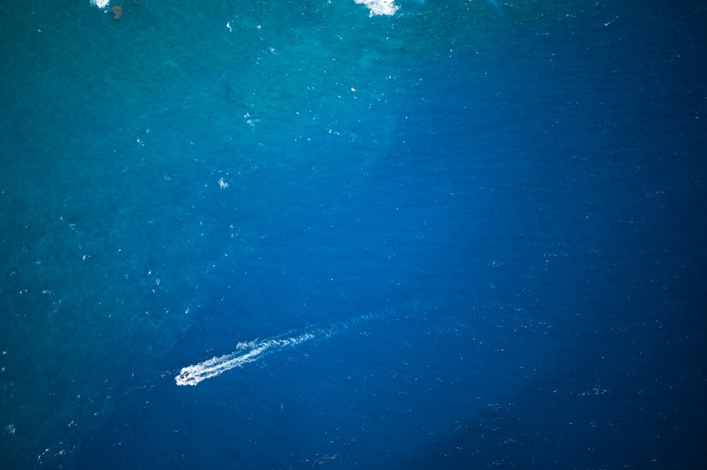 a small boat in the middle of a large body of water