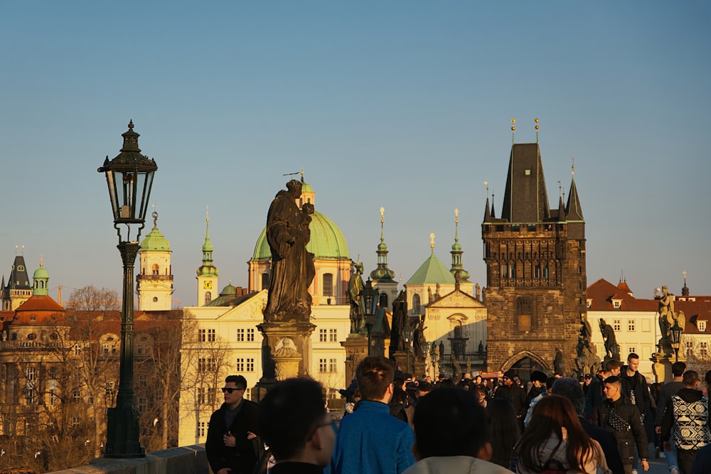 a crowd of people standing around a large building