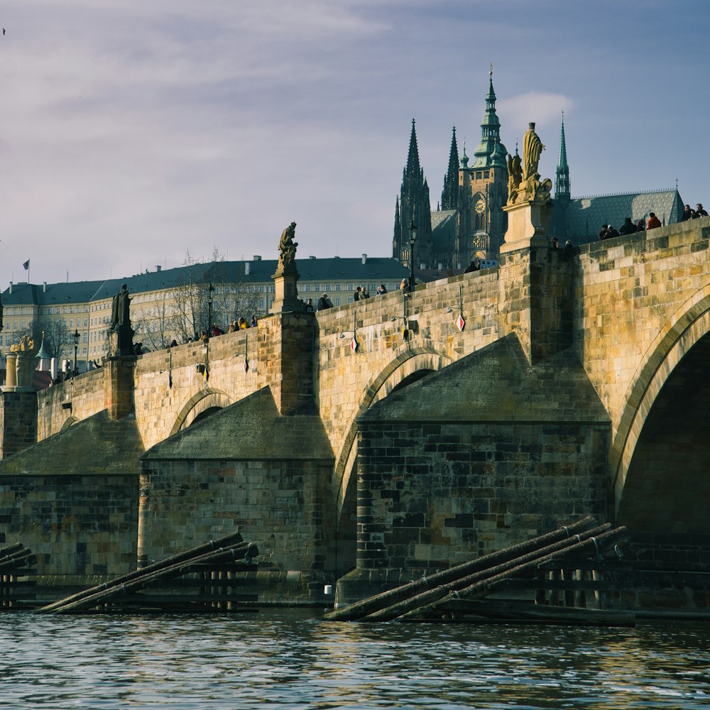 a stone bridge with a castle in the background