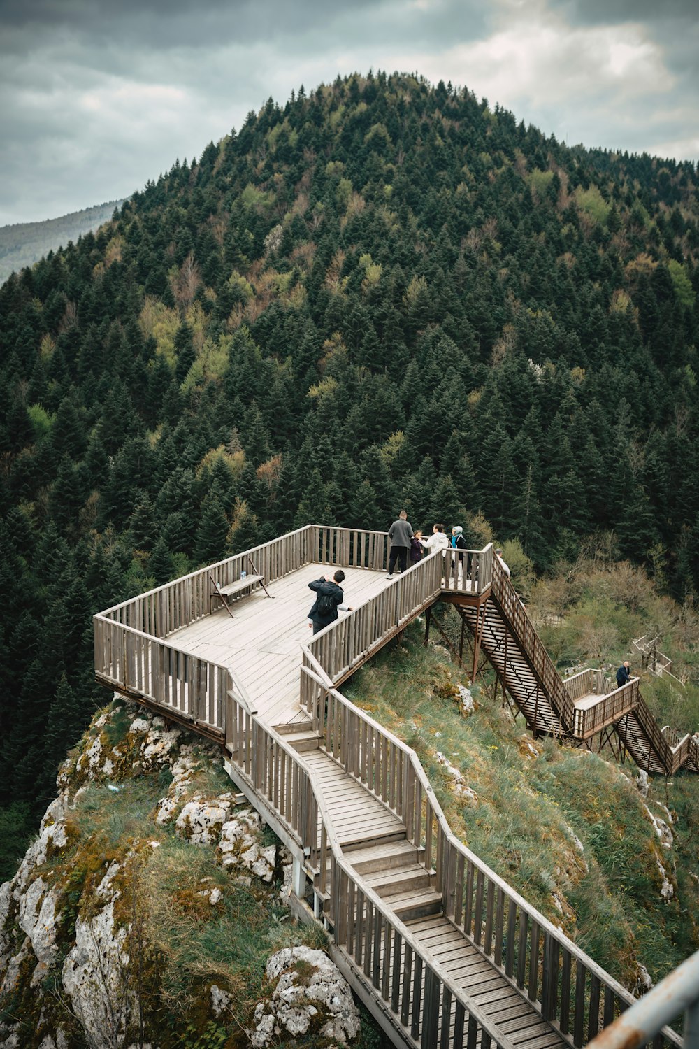 a group of people standing on top of a wooden ramp