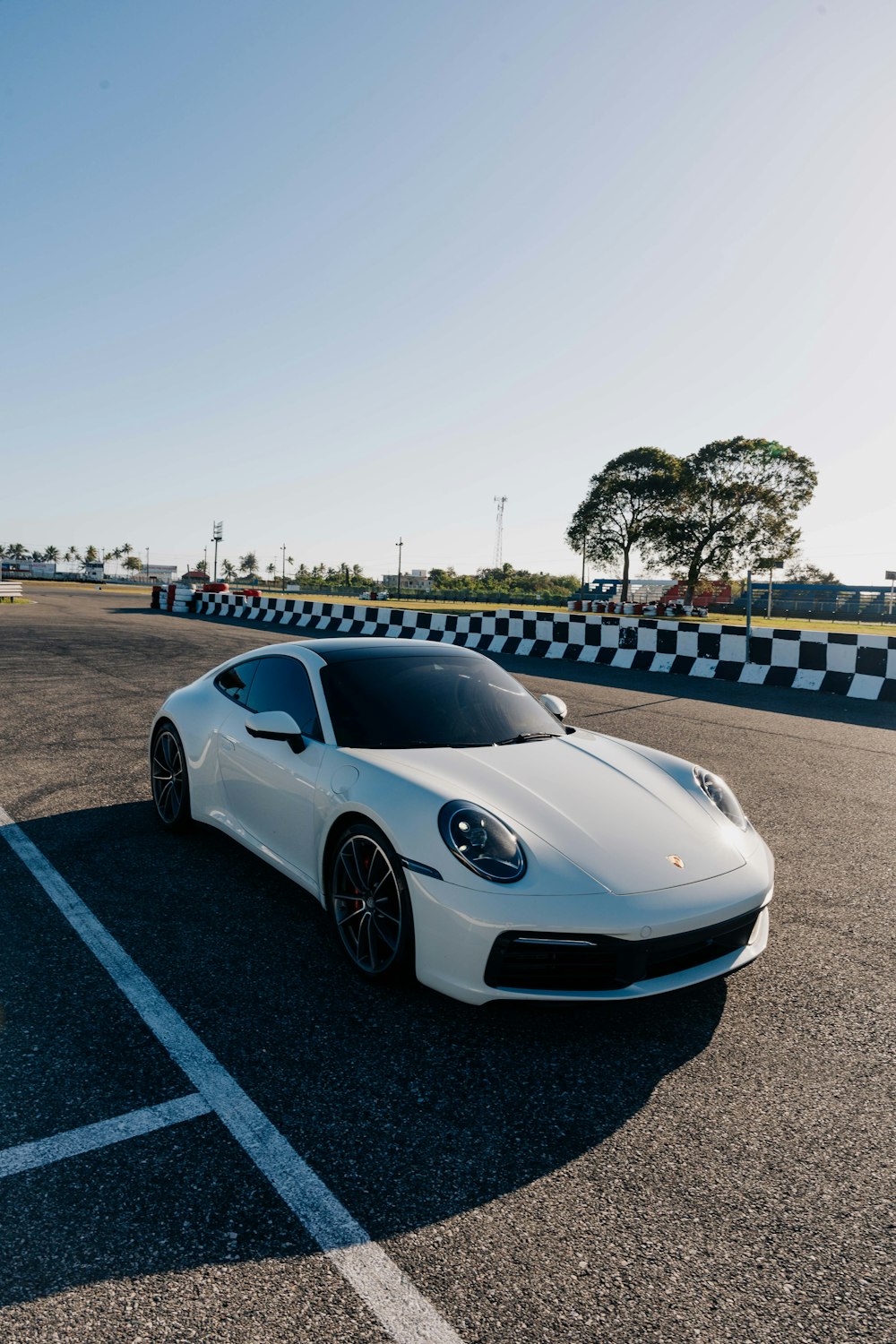 a white sports car parked on a race track