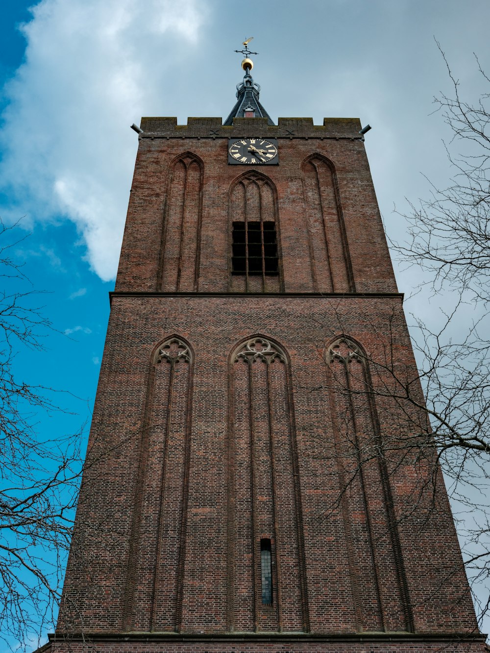 a tall brick tower with a clock on the top