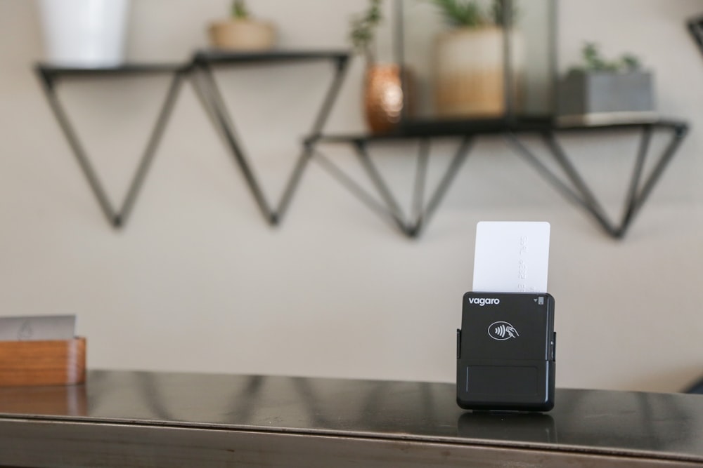 a black and white business card holder on a desk