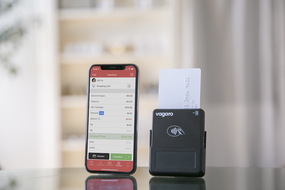 a cell phone sitting on top of a table next to a printer