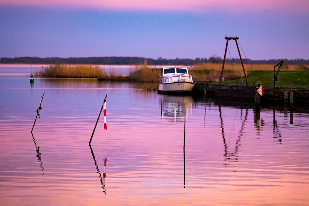 a boat is docked at the end of a pier