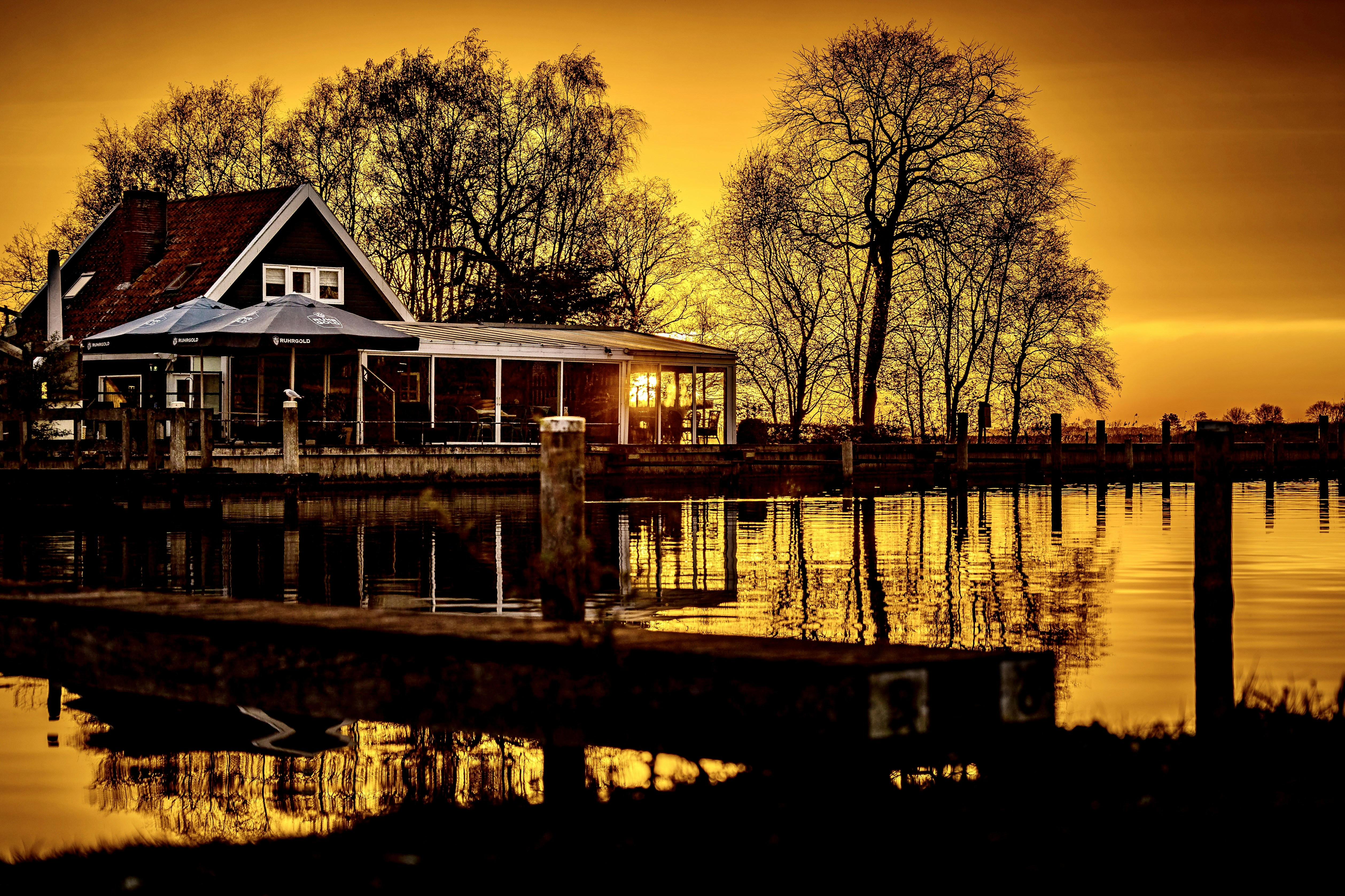 a house sitting on the edge of a body of water