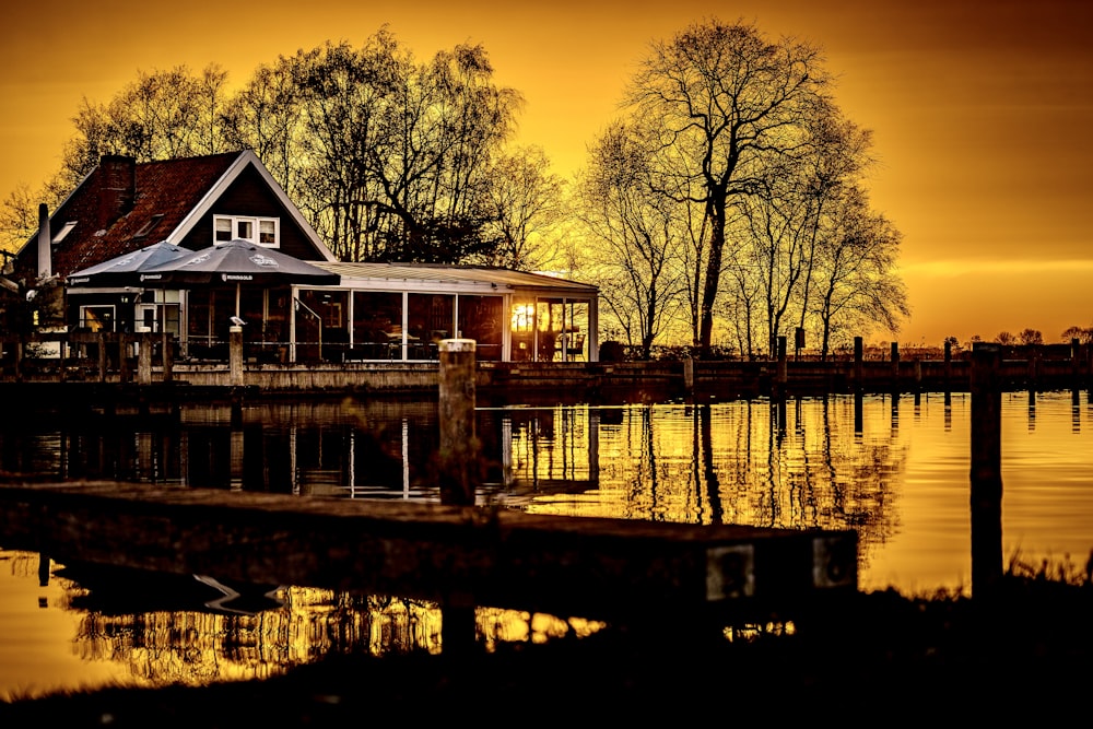 a house sitting on the edge of a body of water