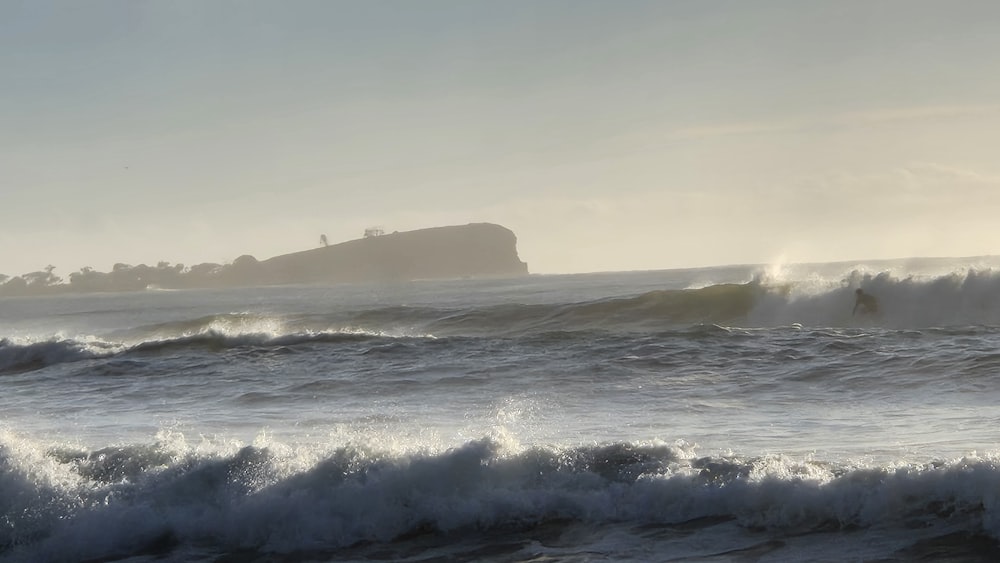 a person riding a surfboard on a wave in the ocean