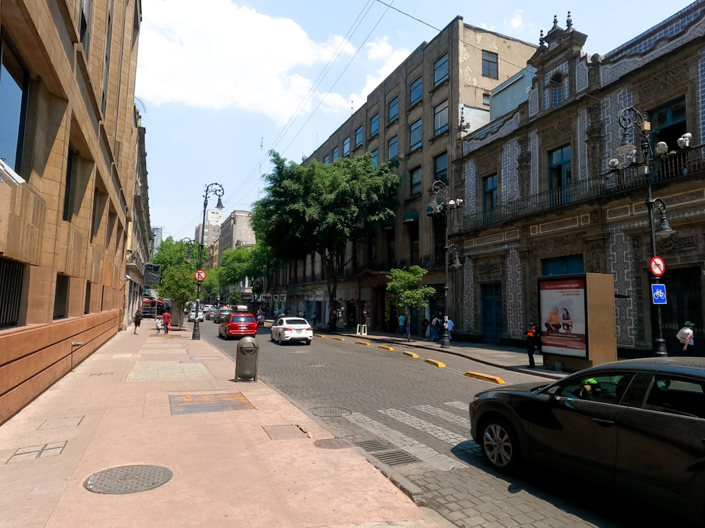 a city street lined with tall buildings and parked cars