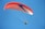 a person is parasailing in the blue sky