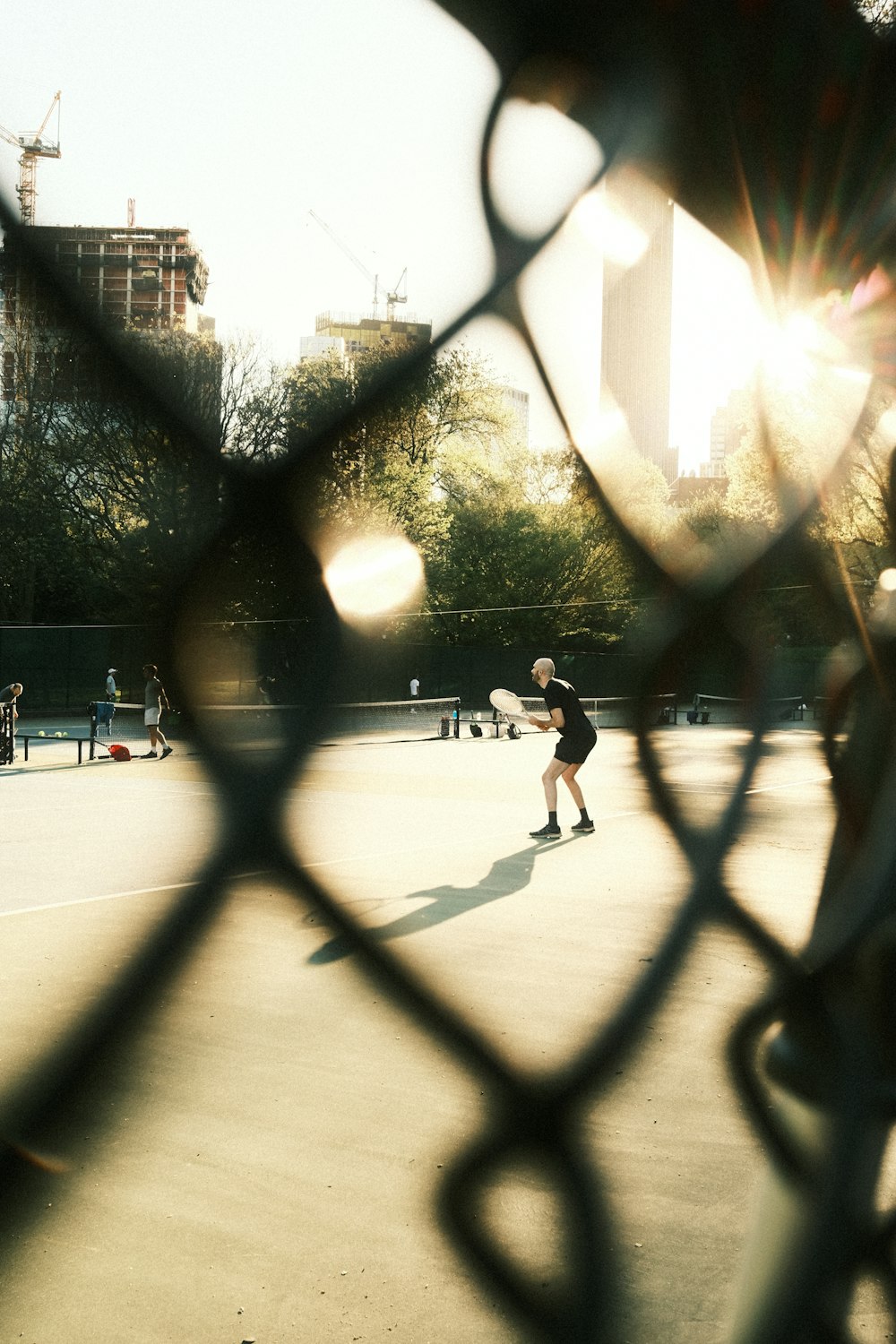 a group of people playing a game of tennis