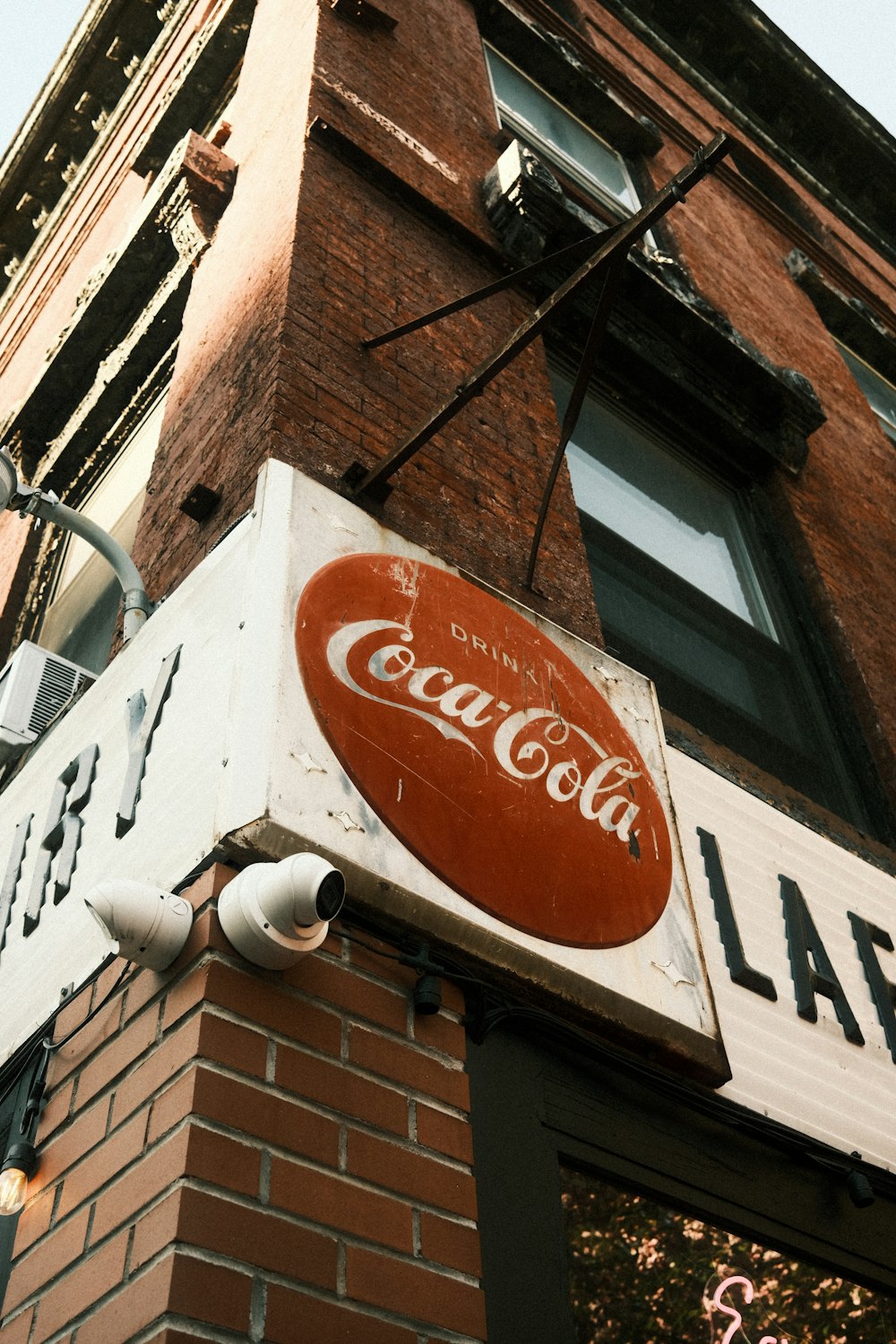 a coca cola sign on the side of a building