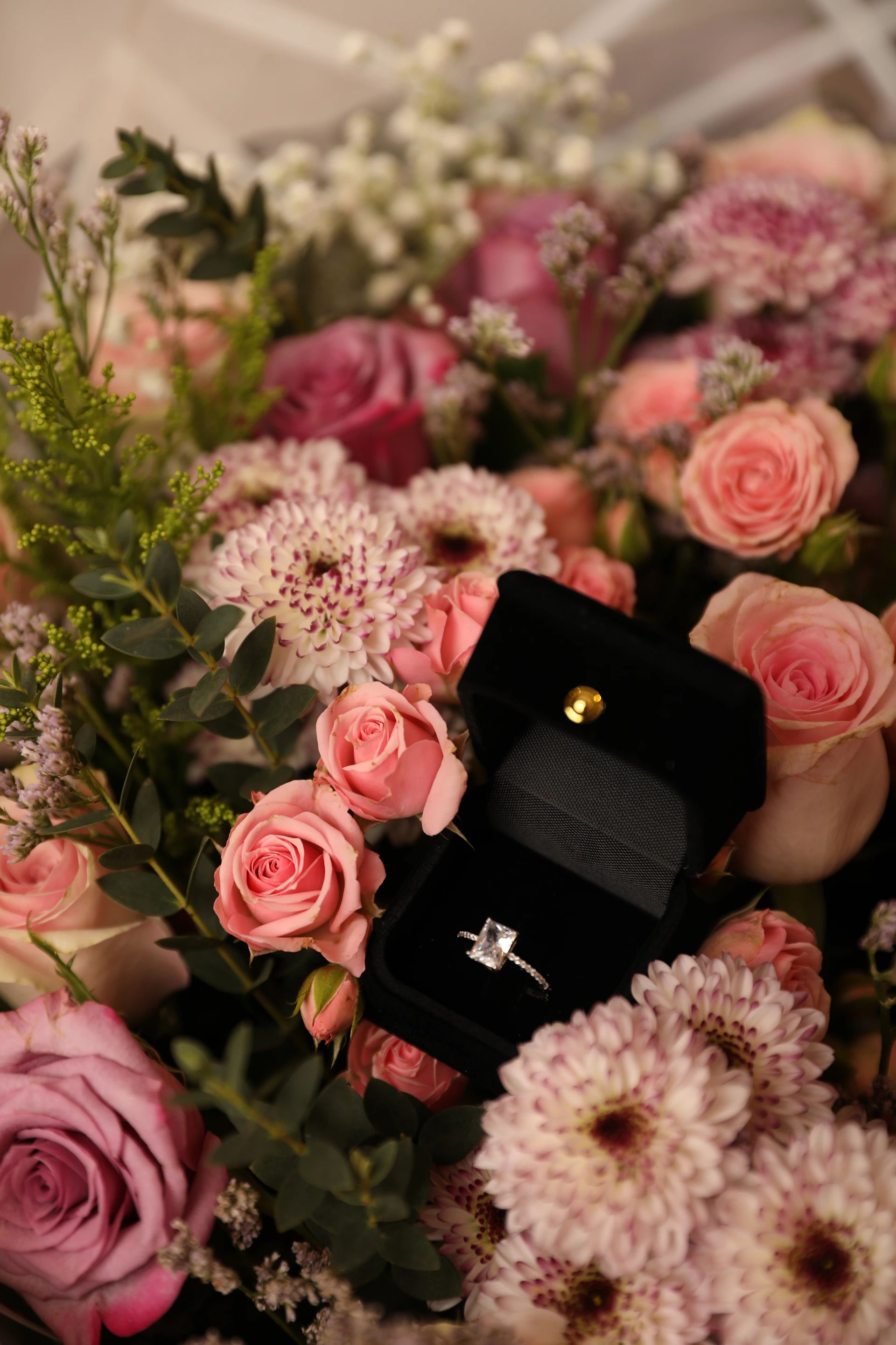 a bouquet of flowers with a ring on it