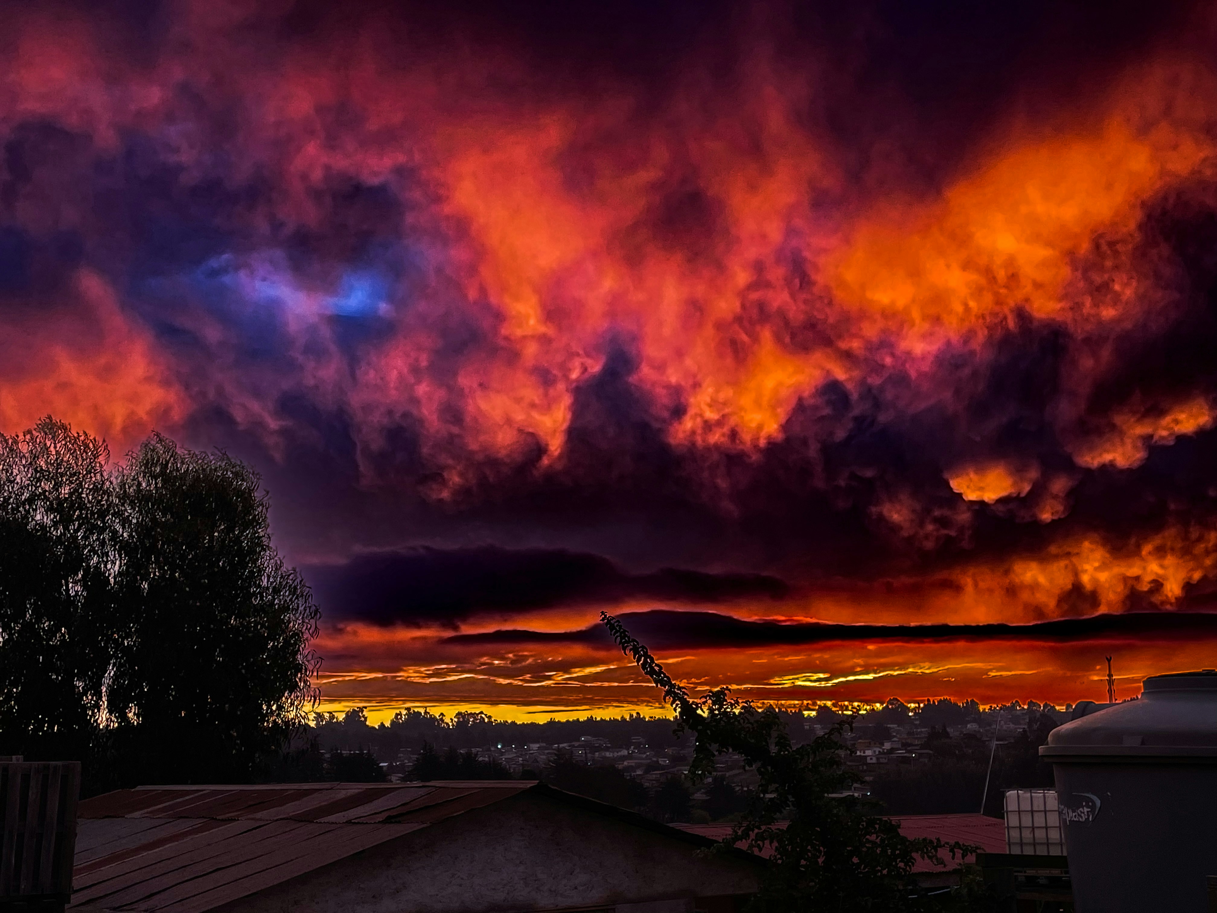Countryside at sunset with dramatic orange and purple sky