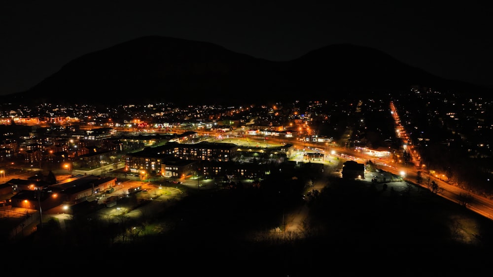 a night view of a city with a mountain in the background