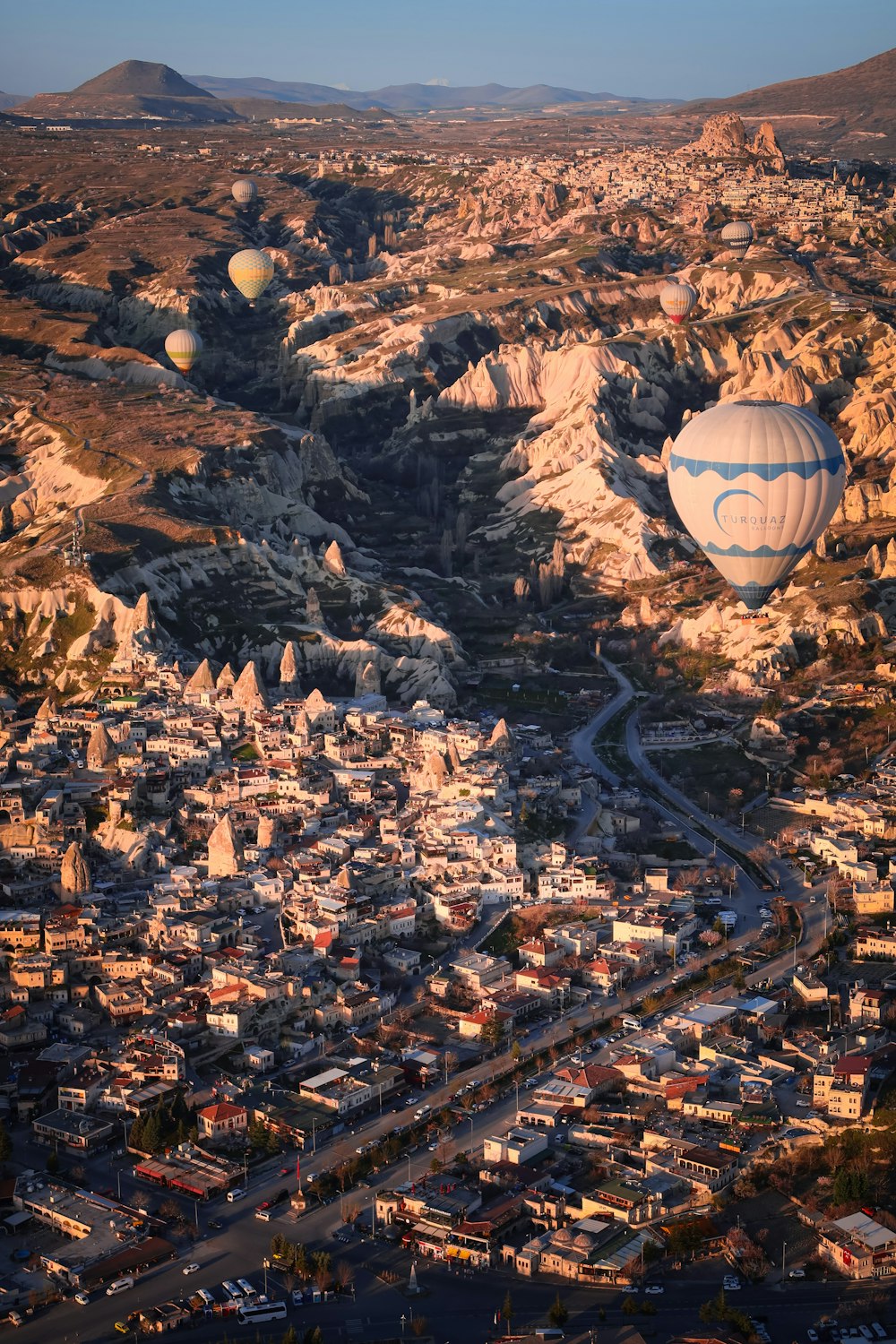 a hot air balloon flying over a city