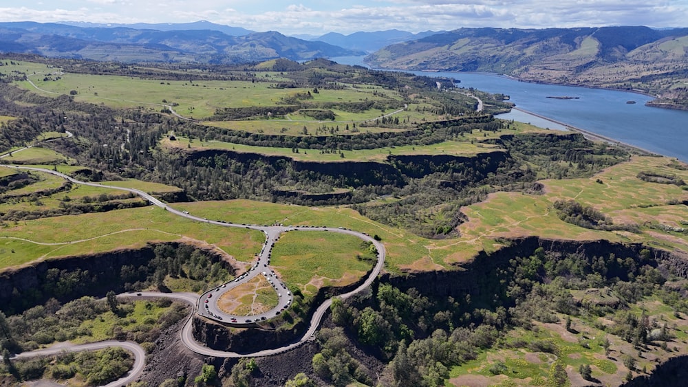 an aerial view of a winding road in the mountains