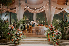 a room filled with lots of tables covered in white drapes