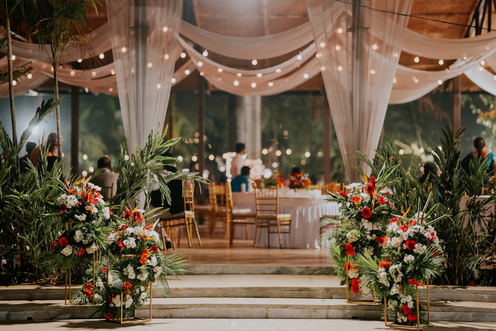 a room filled with lots of tables covered in white drapes