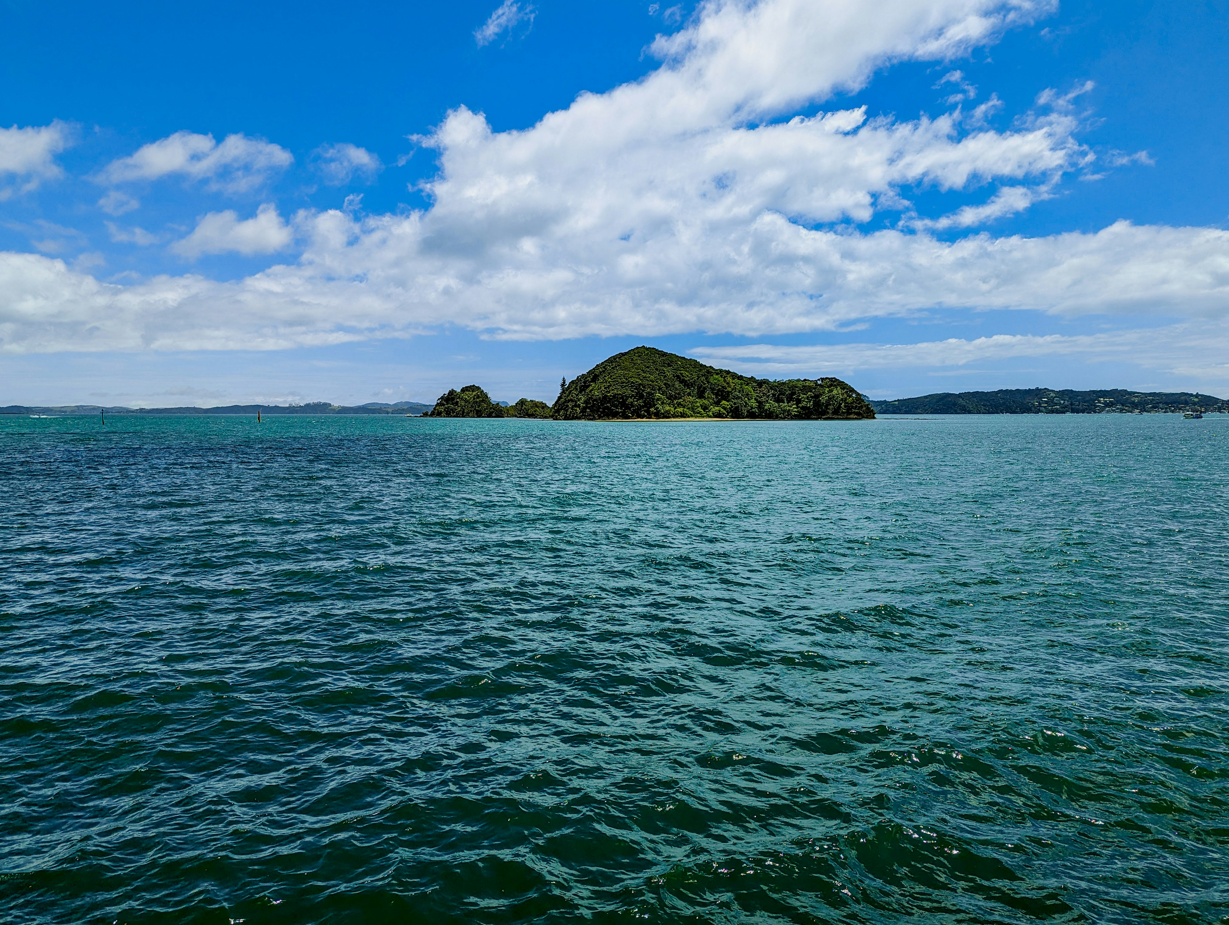 a body of water with a small island in the distance