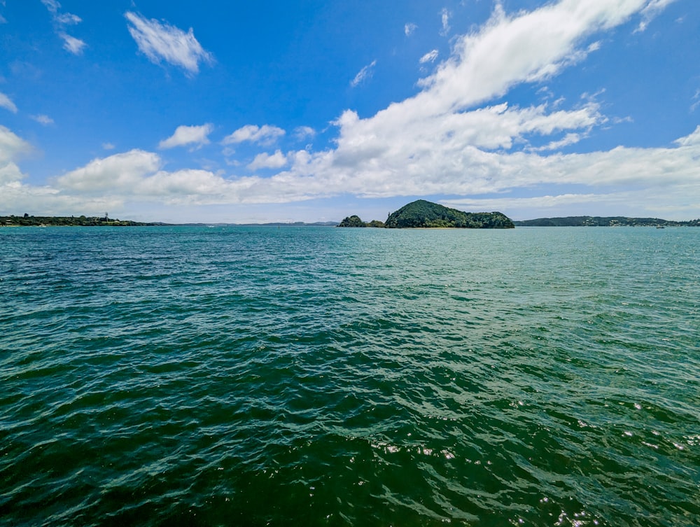 a body of water with a small island in the distance