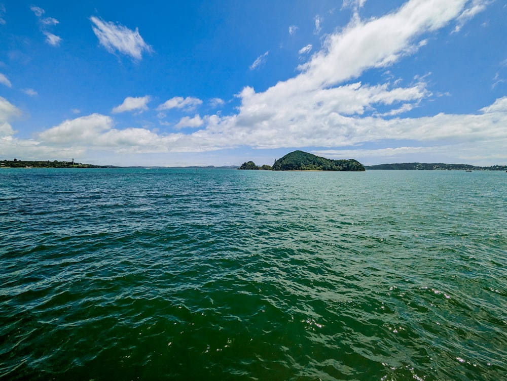 a body of water with a small island in the distance