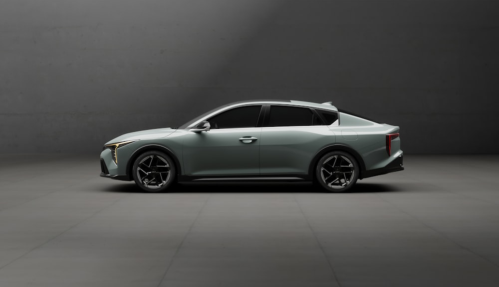 a silver sports car parked in a dark room