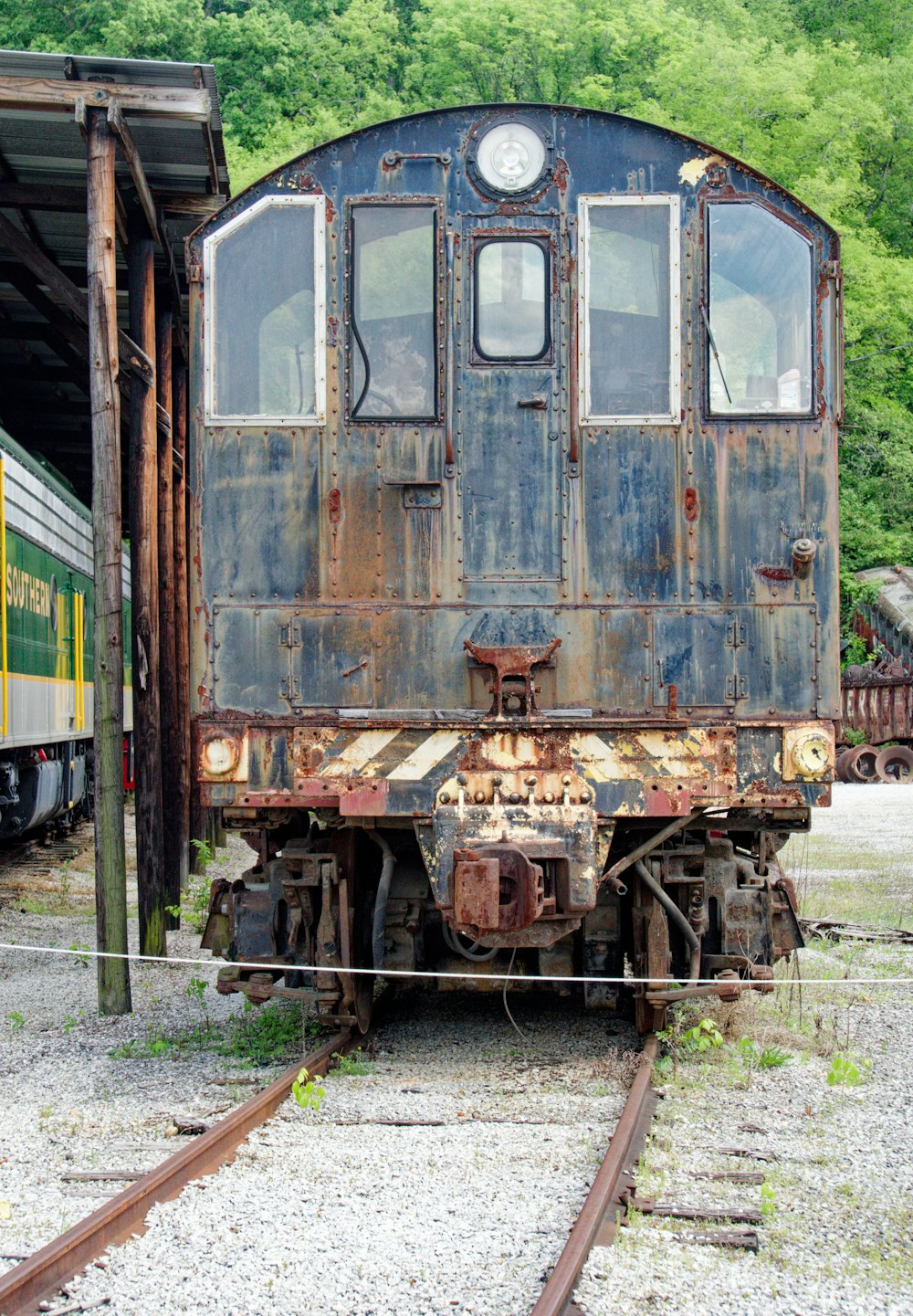 an old rusty train sitting on the tracks