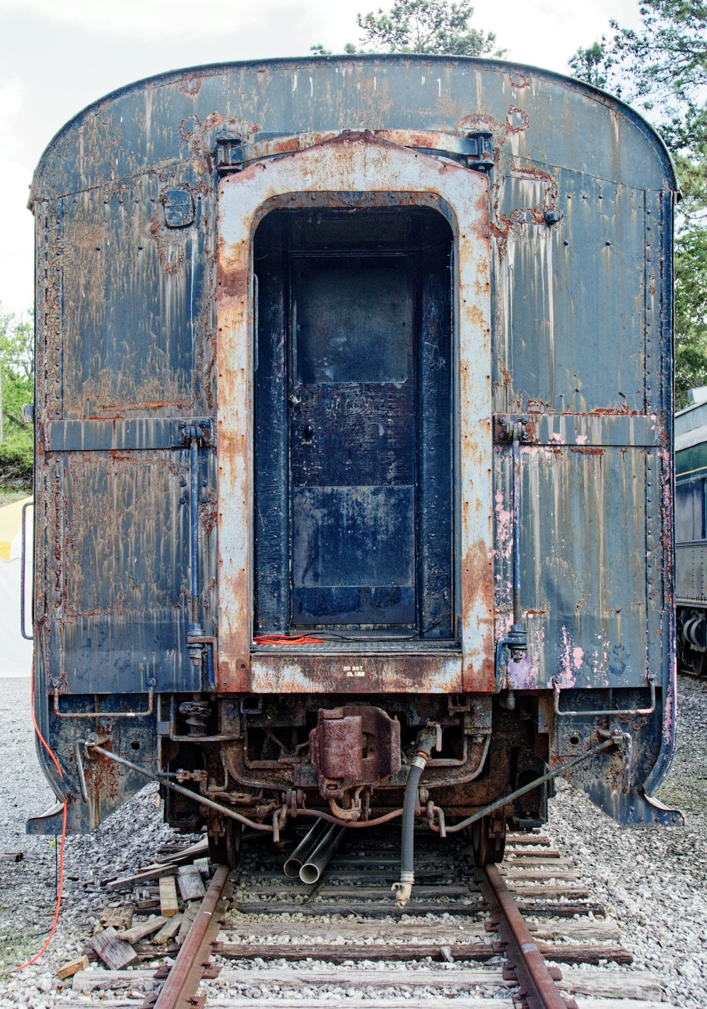 an old rusty train car sitting on the tracks