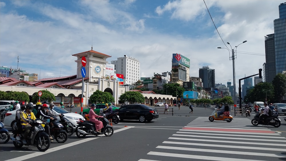 a group of people riding motorcycles down a street