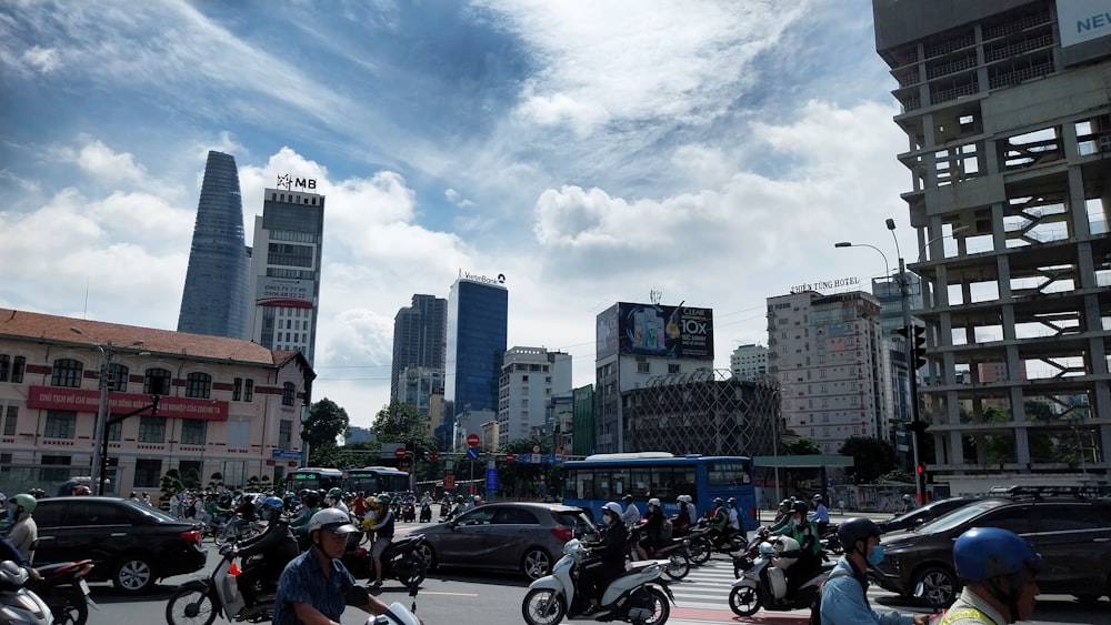 a group of people riding motorcycles down a street