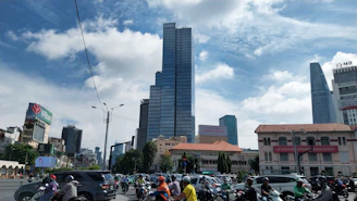 a group of people riding motorcycles down a street